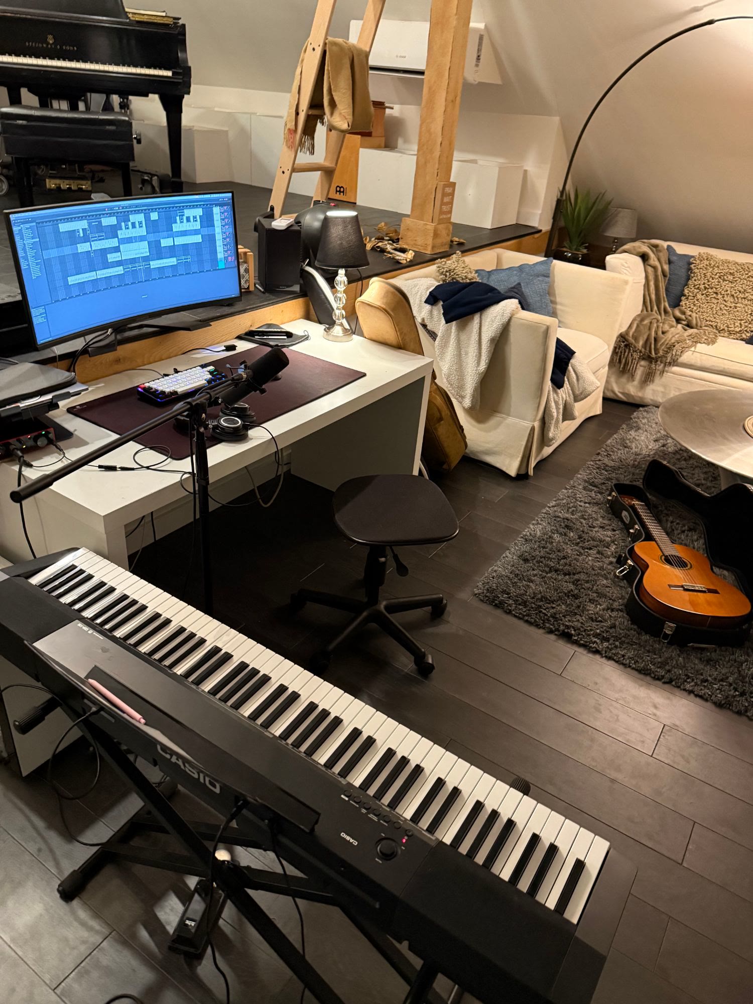 home studio with a digital piano and guitars