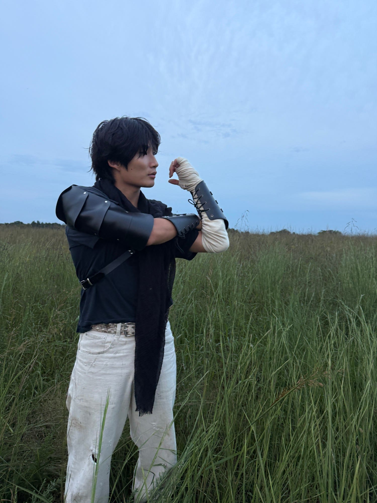 in costume in a tall-grass field